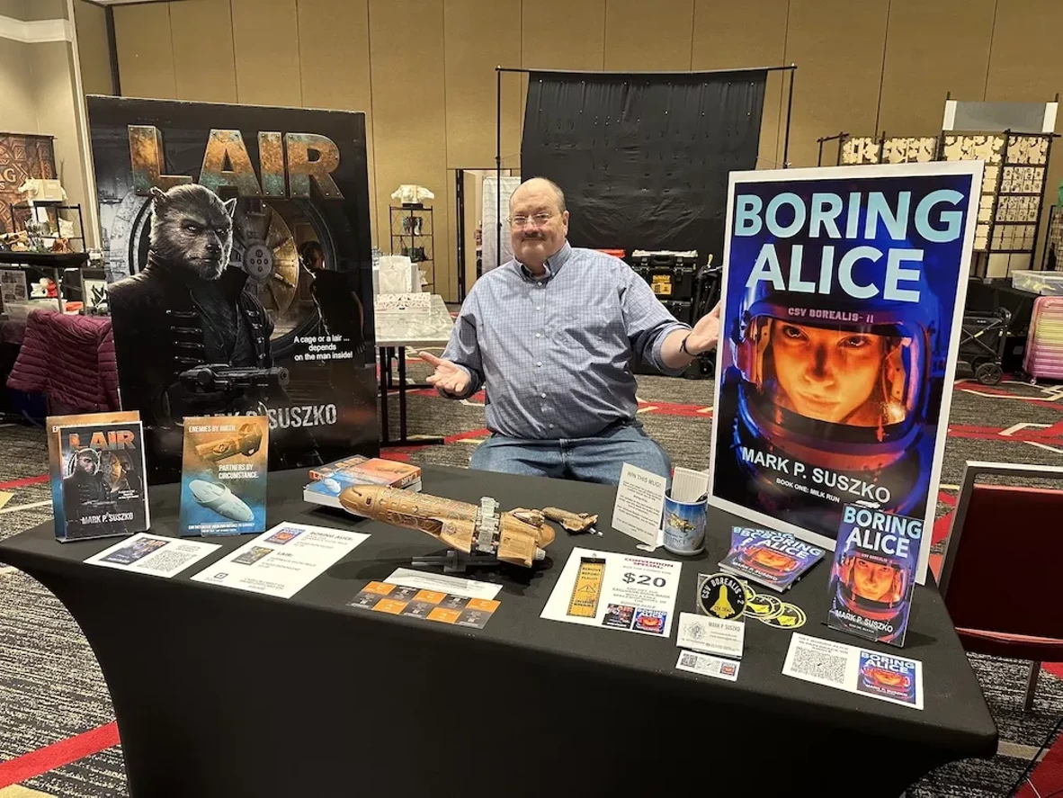 Mark Suszko at recent convention, selling his space opera books.